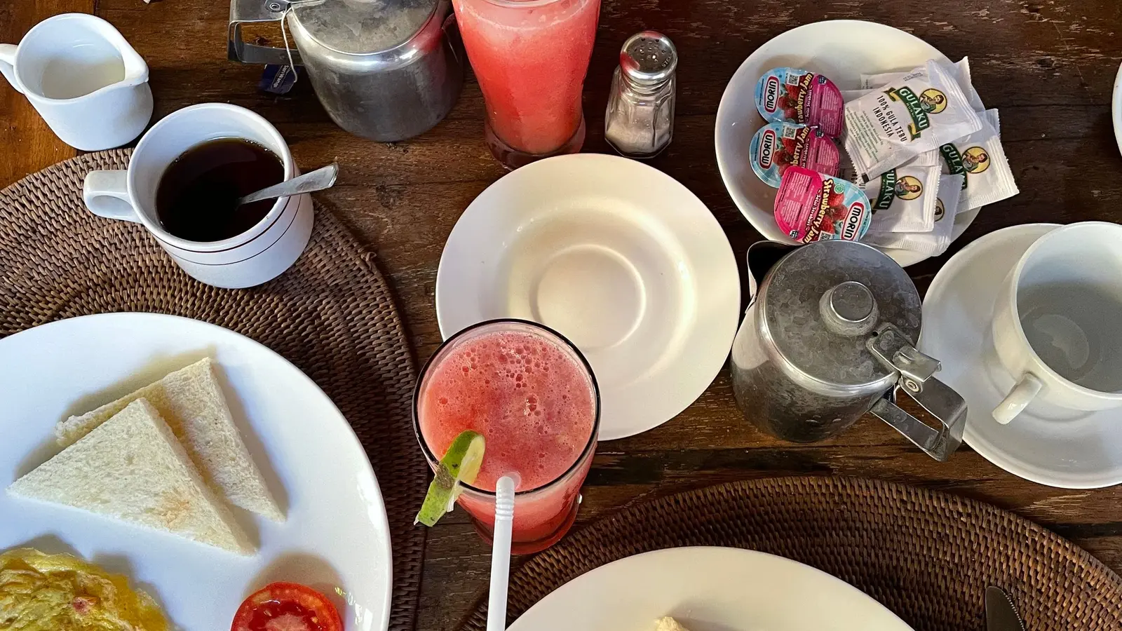 Piring sarapan berisi telur dadar, buah, dan jus